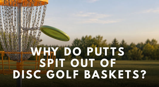 An orange DiscGolfPark basket on a grassy disc golf course as a green putter rebounds from the chains.